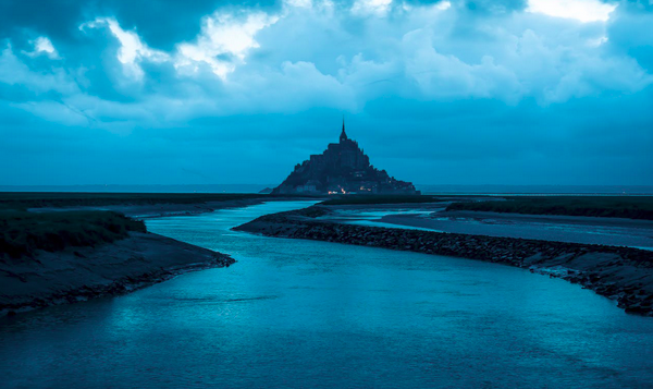 blue river, blue sky, blue spire in the distance